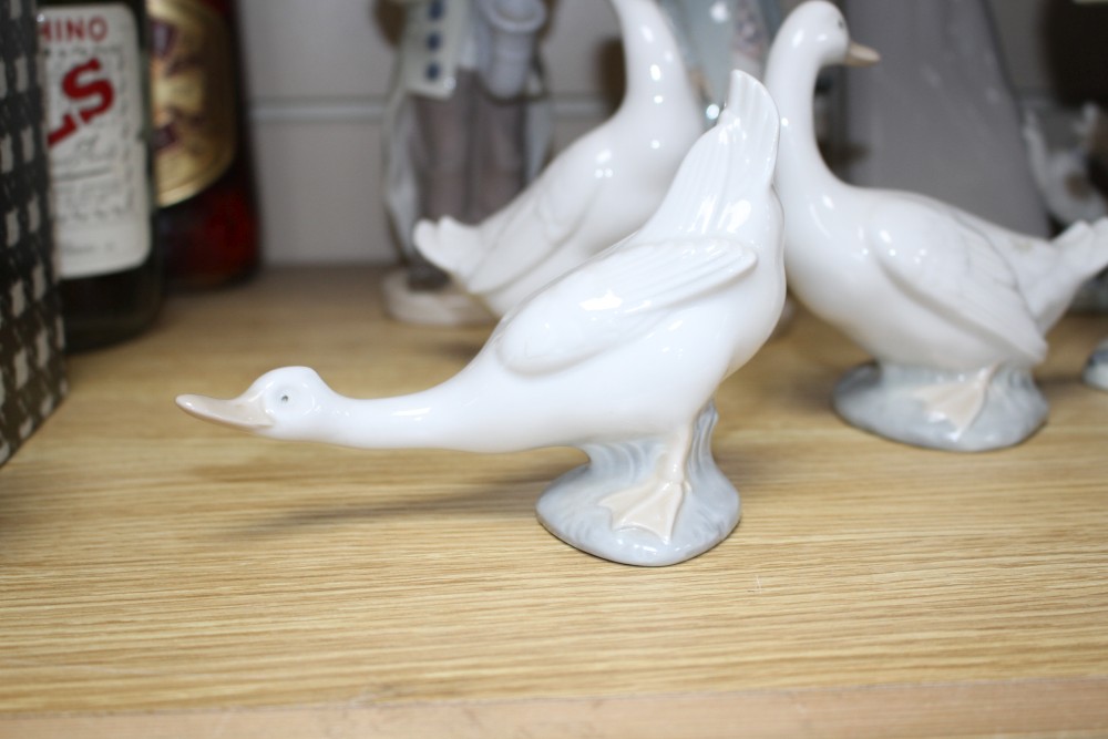 Five assorted Lladro figures and three Nao geese